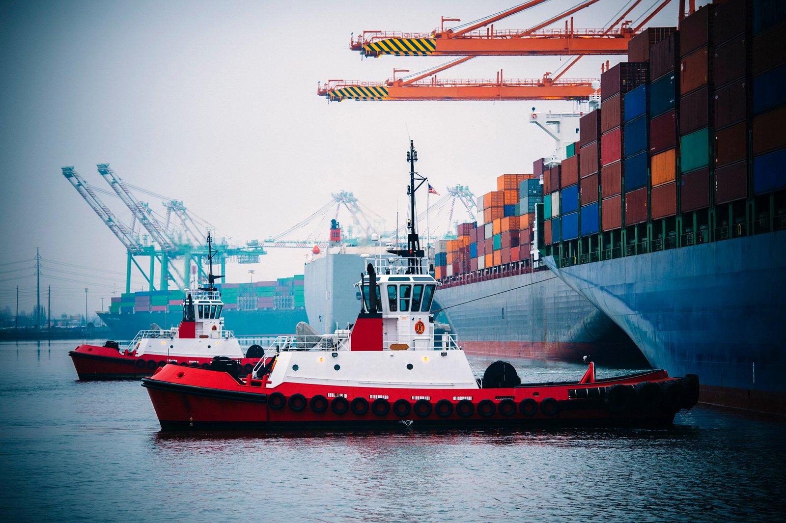 Container ship and tugboats in harbor, Tacoma, Washington, USA